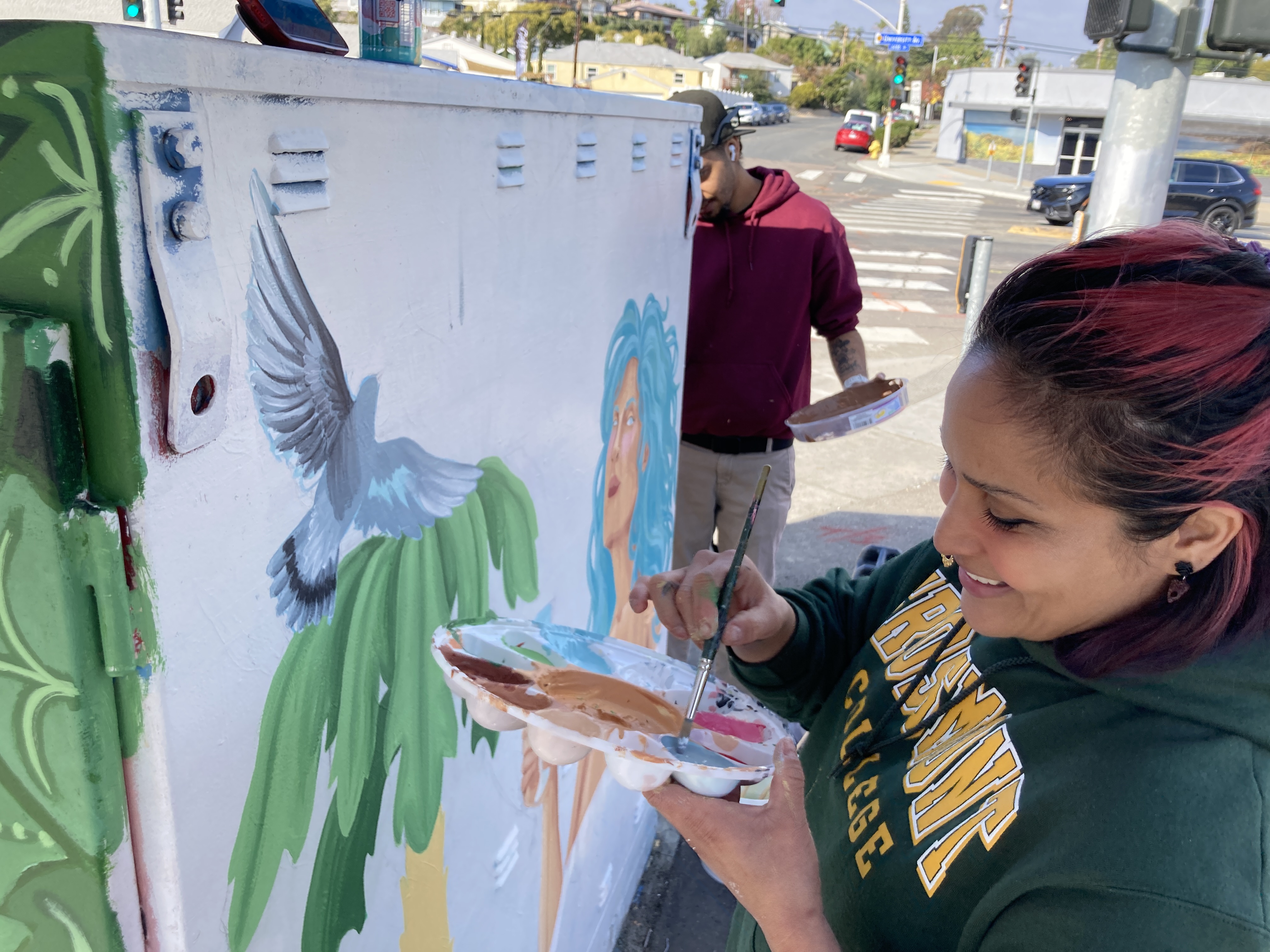 Image of smiling student painting